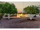 Lush backyard with citrus trees and a shaded patio area provides a calm outdoor setting at 434 N 56Th St, Mesa, AZ 85205