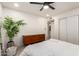 Bedroom with a ceiling fan, dresser, large window and plant accents at 434 N 56Th St, Mesa, AZ 85205