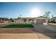 Single-story home with two-car garage, covered porch, and low-maintenance desert landscaping at 434 N 56Th St, Mesa, AZ 85205