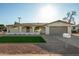 Single-story home with two-car garage, covered porch, and low-maintenance desert landscaping at 434 N 56Th St, Mesa, AZ 85205