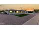 Cozy single-story home featuring a quaint front porch, a well-kept lawn and desert landscaping at 434 N 56Th St, Mesa, AZ 85205