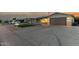 Single-story home with a two-car garage, artificial turf lawn, desert landscaping and covered porch at 434 N 56Th St, Mesa, AZ 85205