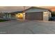 Single-story home with a two-car garage, artificial turf lawn, desert landscaping and covered porch at 434 N 56Th St, Mesa, AZ 85205