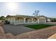 Single-story home with desert landscaping, two-car garage and covered front porch with seating area at 434 N 56Th St, Mesa, AZ 85205