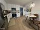 Bright kitchen featuring stainless steel appliances, white cabinets, and a cozy dining area at 434 N 56Th St, Mesa, AZ 85205