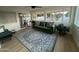 Sunroom featuring a green sofa, neutral rug, large windows with backyard view, and sliding doors at 434 N 56Th St, Mesa, AZ 85205