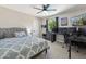 Comfortable bedroom with a ceiling fan, work desk, and large window for natural light at 438 E Larkspur Ln, Tempe, AZ 85288