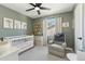 Welcoming Bedroom with crib, comfortable chair, overhead fan and window with natural light at 438 E Larkspur Ln, Tempe, AZ 85288