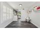 Well-lit dining area with wood-look floors, white trim, and view into updated kitchen at 438 E Larkspur Ln, Tempe, AZ 85288