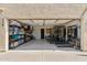 Spacious garage with an open door, featuring ample storage shelves and workout equipment at 438 E Larkspur Ln, Tempe, AZ 85288