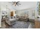 Comfortable living room features a large sectional sofa, ceiling fan, and wood-look flooring at 438 E Larkspur Ln, Tempe, AZ 85288