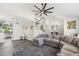 Open-concept living room featuring a large sectional sofa, stairway, and views into the kitchen at 438 E Larkspur Ln, Tempe, AZ 85288