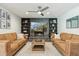 Cozy basement living room features a stone fireplace, comfortable sofas, and modern decor at 438 E Larkspur Ln, Tempe, AZ 85288