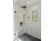 Modern shower with black hardware, white subway tile surround and useful shampoo storage nook at 438 E Larkspur Ln, Tempe, AZ 85288
