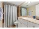 A bathroom has a sink with granite counters, a mirrored cabinet, and a shower with a blue curtain at 4600 N 68Th St # 379, Scottsdale, AZ 85251
