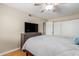 A neutral bedroom includes a gray dresser, ceiling fan, and closet with sliding doors at 4600 N 68Th St # 379, Scottsdale, AZ 85251