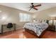 A well-lit bedroom features a ceiling fan, wood floors, a desk, and a full bed at 4600 N 68Th St # 379, Scottsdale, AZ 85251