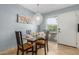Charming dining area with a modern chandelier, table setting and natural light from the window at 4600 N 68Th St # 379, Scottsdale, AZ 85251