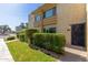 Exterior view of a two-story condo with lush green landscaping and private front door entrance at 4600 N 68Th St # 379, Scottsdale, AZ 85251