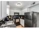 The kitchen features black appliances, white cabinets, and dark countertops at 4600 N 68Th St # 379, Scottsdale, AZ 85251