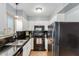 A functional kitchen features black appliances, dark countertops, and white cabinets at 4600 N 68Th St # 379, Scottsdale, AZ 85251