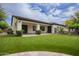 Back of house showing patio, lawn, and manicured desert landscaping at 4711 E Buckboard Ct, Gilbert, AZ 85297
