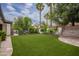 Lush artificial grass in backyard with desert landscaping and privacy wall at 4711 E Buckboard Ct, Gilbert, AZ 85297