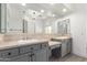 Bathroom vanity with double sinks, stone countertop, gray cabinets and tile flooring at 4711 E Buckboard Ct, Gilbert, AZ 85297