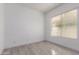 Bedroom with wood-style tile floors, a large window, and white trim at 4711 E Buckboard Ct, Gilbert, AZ 85297