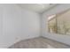 Bedroom with wood-style tile floors, a large window, and white trim at 4711 E Buckboard Ct, Gilbert, AZ 85297