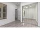 Bright bedroom features neutral colors, mirrored closet, and view to tiled bathroom and window at 4711 E Buckboard Ct, Gilbert, AZ 85297