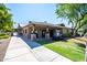 Exterior view of the community center with covered walkways and manicured lawn at 4711 E Buckboard Ct, Gilbert, AZ 85297