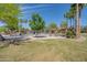 Inviting community park with playground, picnic tables, and lush landscaping under a clear blue sky at 4711 E Buckboard Ct, Gilbert, AZ 85297
