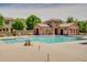 Inviting community pool with a decorative pool house, perfect for relaxation and leisure at 4711 E Buckboard Ct, Gilbert, AZ 85297