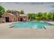 Sparkling community pool with a decorative pool house offers a relaxing outdoor space for residents at 4711 E Buckboard Ct, Gilbert, AZ 85297