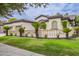 Charming single-story home features a well-manicured lawn, complemented by a decorative fence and lush landscaping at 4711 E Buckboard Ct, Gilbert, AZ 85297