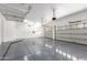 Spacious two car garage is equipped with epoxy flooring and ceiling storage racks at 4711 E Buckboard Ct, Gilbert, AZ 85297