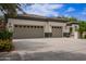 Attractive home showcases a spacious three-car garage and large driveway with mature landscaping at 4711 E Buckboard Ct, Gilbert, AZ 85297