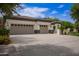 Attractive home showcases a spacious three-car garage and large driveway with mature landscaping at 4711 E Buckboard Ct, Gilbert, AZ 85297