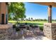 Outdoor grilling area with lush green lawn and trees for community members to enjoy at 4711 E Buckboard Ct, Gilbert, AZ 85297