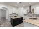 Kitchen showcasing a center island, granite countertops, white cabinets, and stainless steel appliances at 4711 E Buckboard Ct, Gilbert, AZ 85297