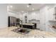 Well-equipped kitchen featuring granite countertops, white cabinetry, and modern stainless steel appliances at 4711 E Buckboard Ct, Gilbert, AZ 85297