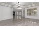 Expansive living room with a modern chandelier, fireplace, and elegant tiled floors at 4711 E Buckboard Ct, Gilbert, AZ 85297