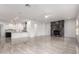 Bright living room featuring a marble fireplace and an open-concept design flowing into the kitchen at 4711 E Buckboard Ct, Gilbert, AZ 85297