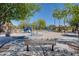 Community park featuring playground, picnic areas, ramadas, and seating on concrete pathway at 4711 E Buckboard Ct, Gilbert, AZ 85297