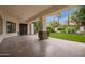 Covered patio with tile flooring, ceiling fan, and views of palm trees and landscape at 4711 E Buckboard Ct, Gilbert, AZ 85297
