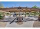 Community pavilion with picnic tables, stone pillars and shade, near playground at 4711 E Buckboard Ct, Gilbert, AZ 85297