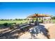 Charming covered picnic area with stone pillars and barbecue, a great community space for outdoor dining at 4711 E Buckboard Ct, Gilbert, AZ 85297