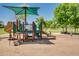 Community playground with multiple features, including slides, stairs, and shade structure at 4711 E Buckboard Ct, Gilbert, AZ 85297
