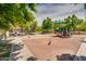 Community playground with benches, play equipment, and safety surface at 4711 E Buckboard Ct, Gilbert, AZ 85297